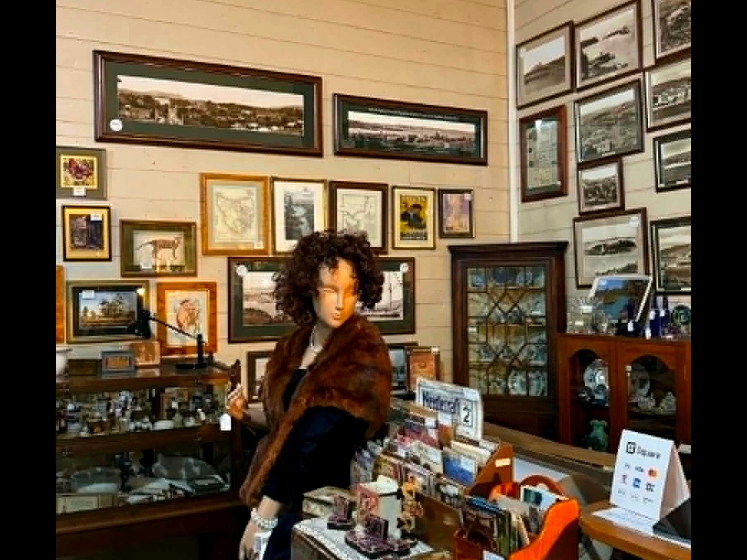 Historic photographs, prints and mannequin with vintage fur stole