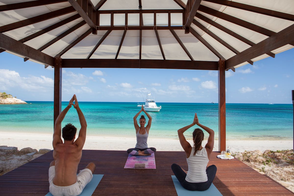 Morning yoga session on Anchor Bay beach at Lizard Island