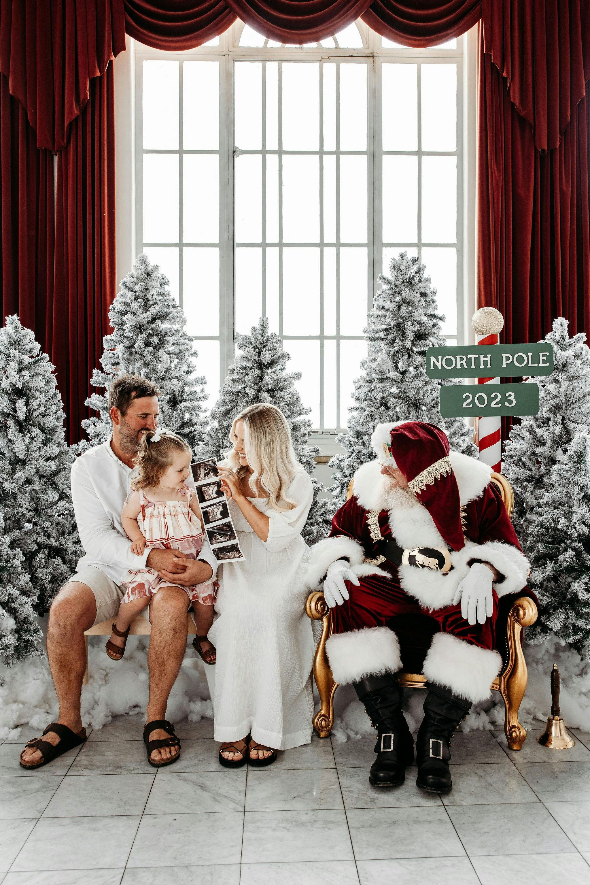 Family sitting next to santa