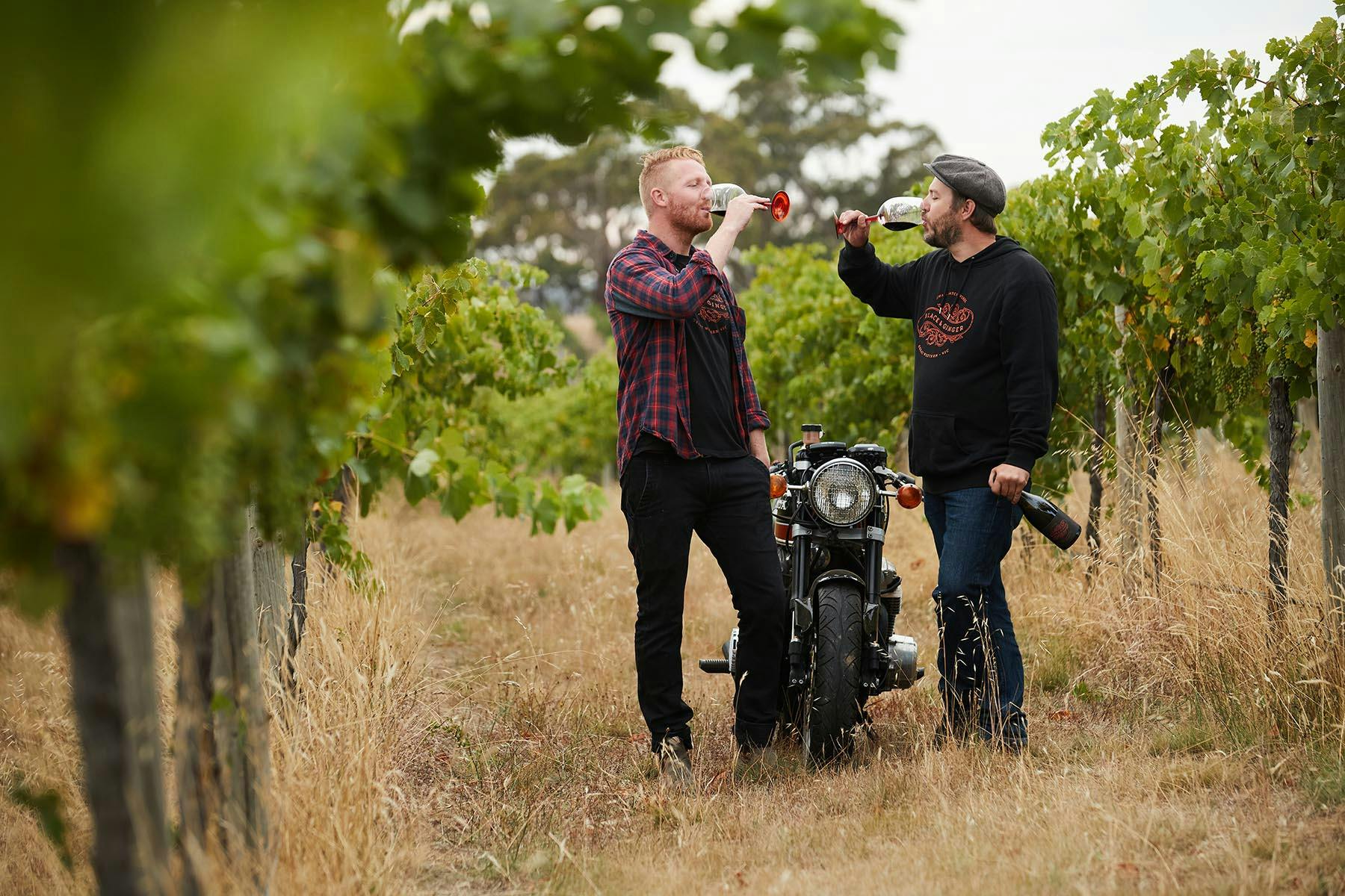 Hadyn and Darcy in the vineyard tasting wine