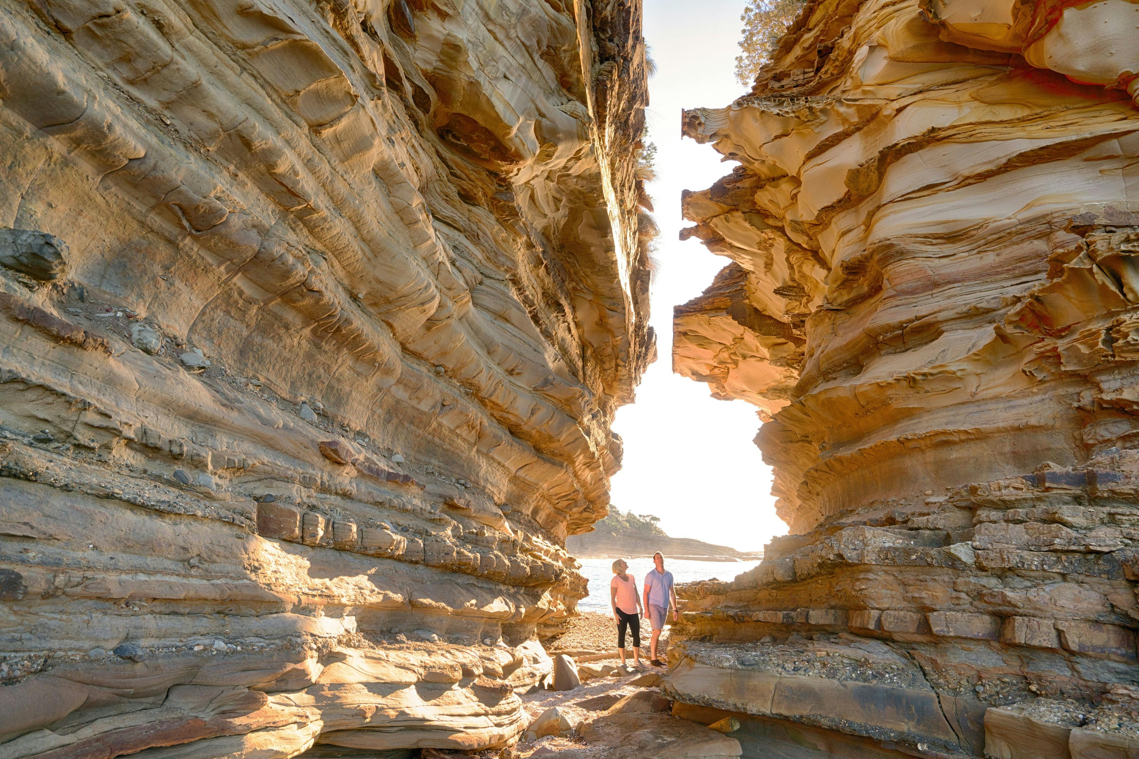 Couple enjoying a scenic morning walk around Wasps Head,  Murramarang National Park
