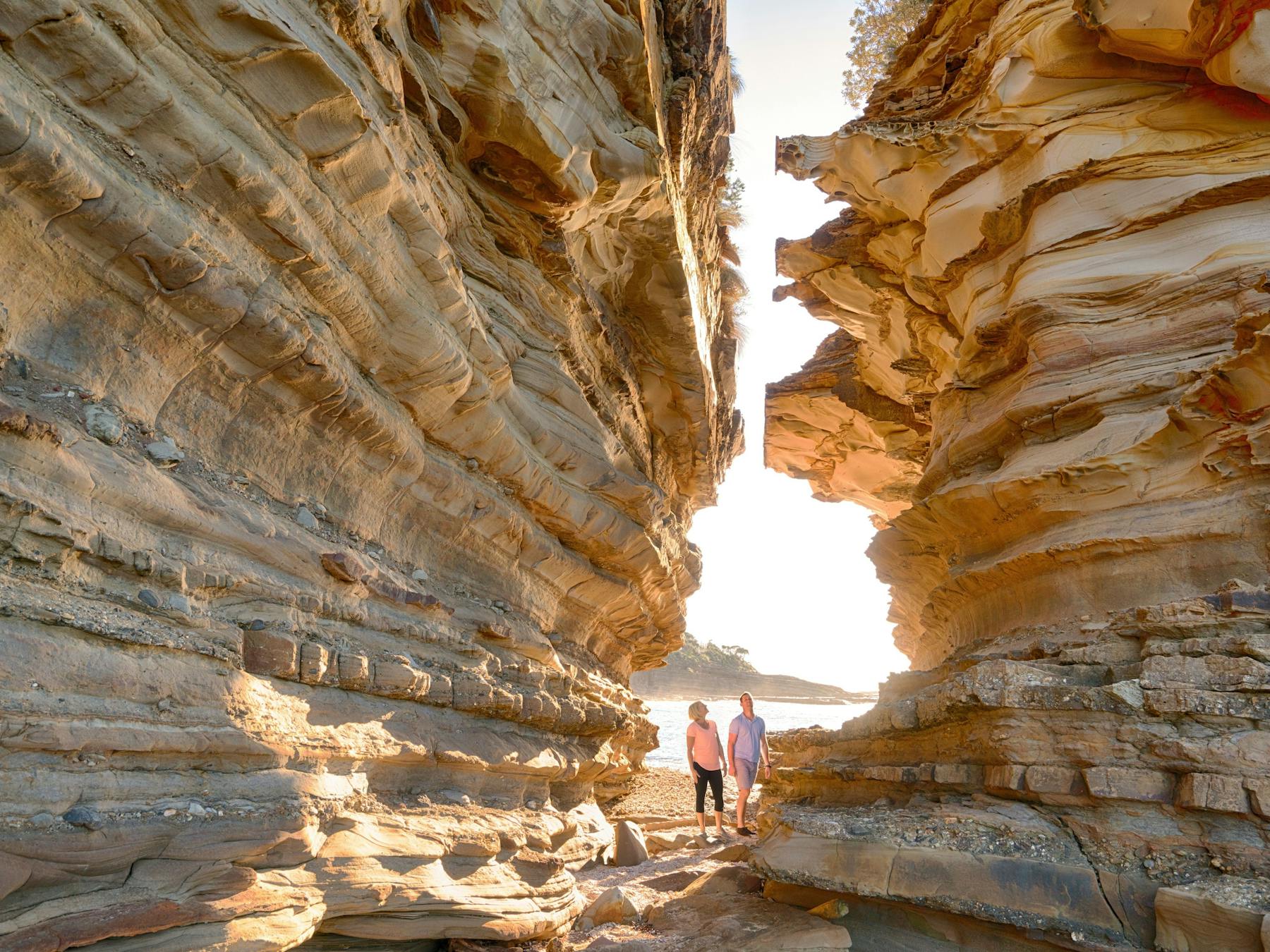 Couple enjoying a scenic morning walk around Wasps Head, Murramarang National Park