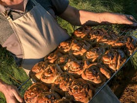 A tray of baked goods being held by the baker at Farina bakery