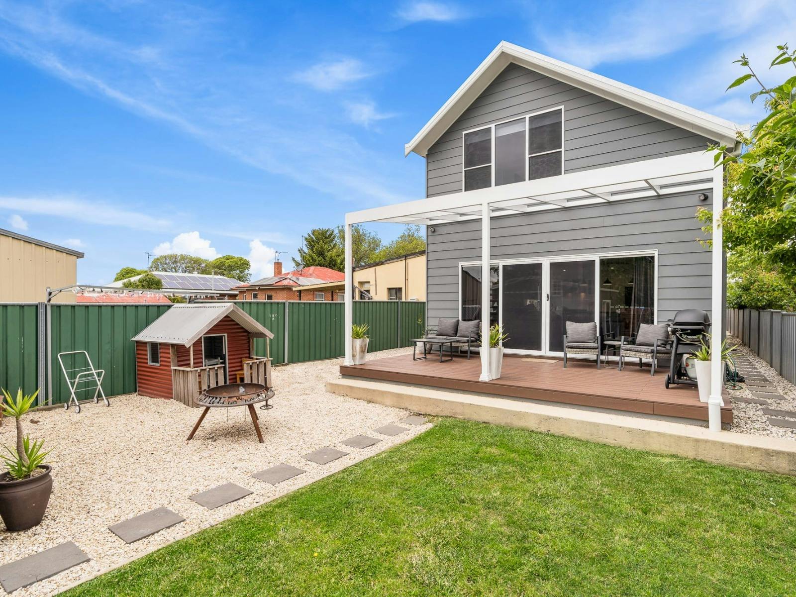 Backyard with deck, cubby house and studio