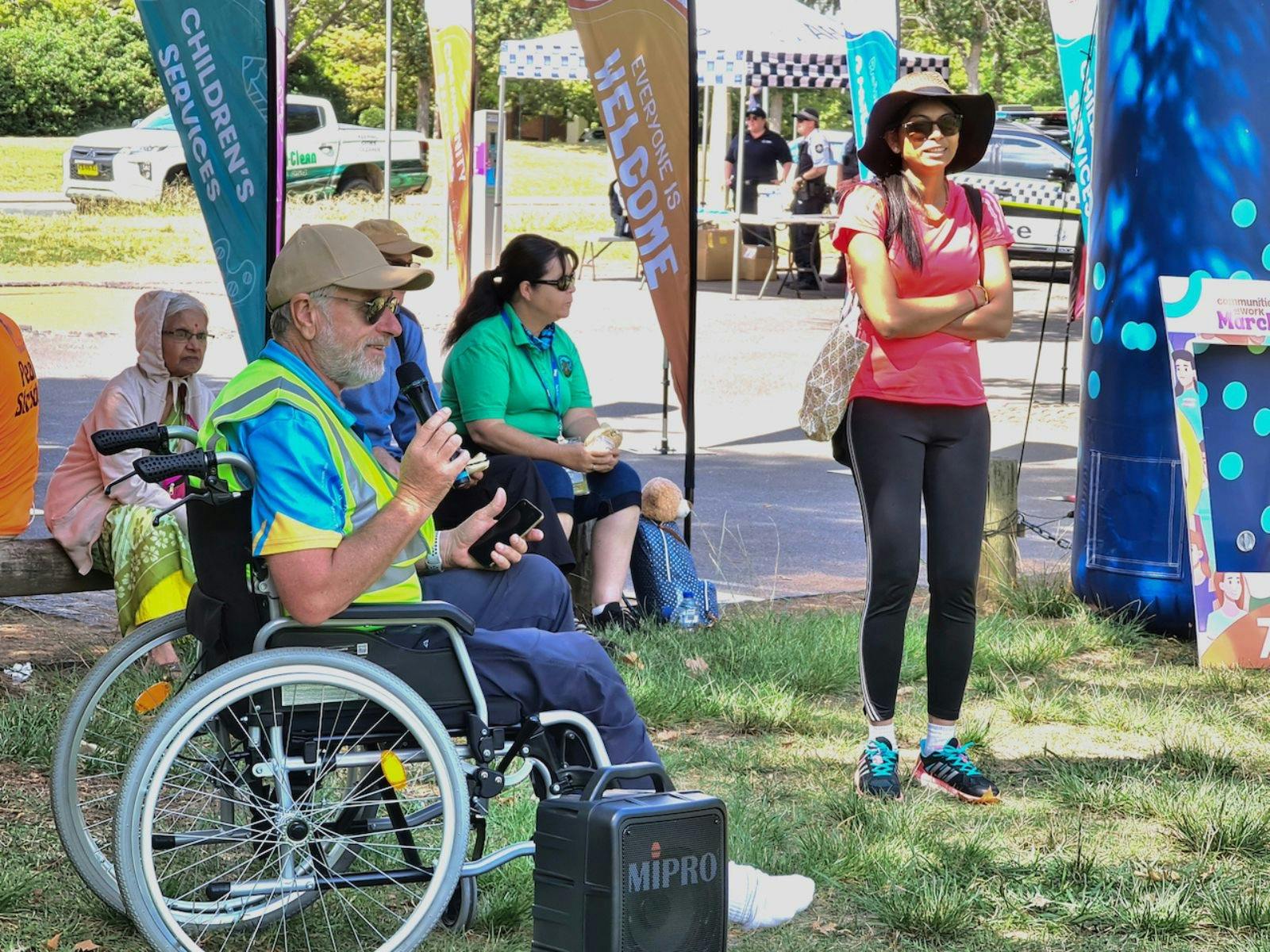 a man in a wheelchair with a microphone