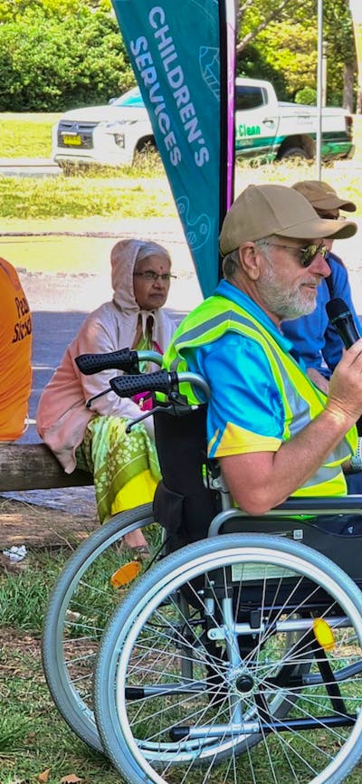 a man in a wheelchair with a microphone