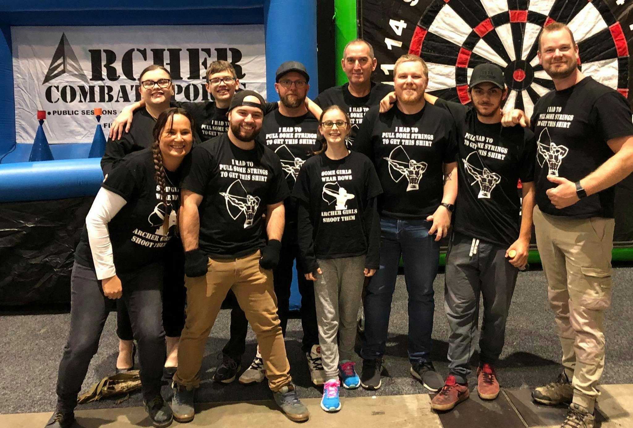 A group of people in front of a large target