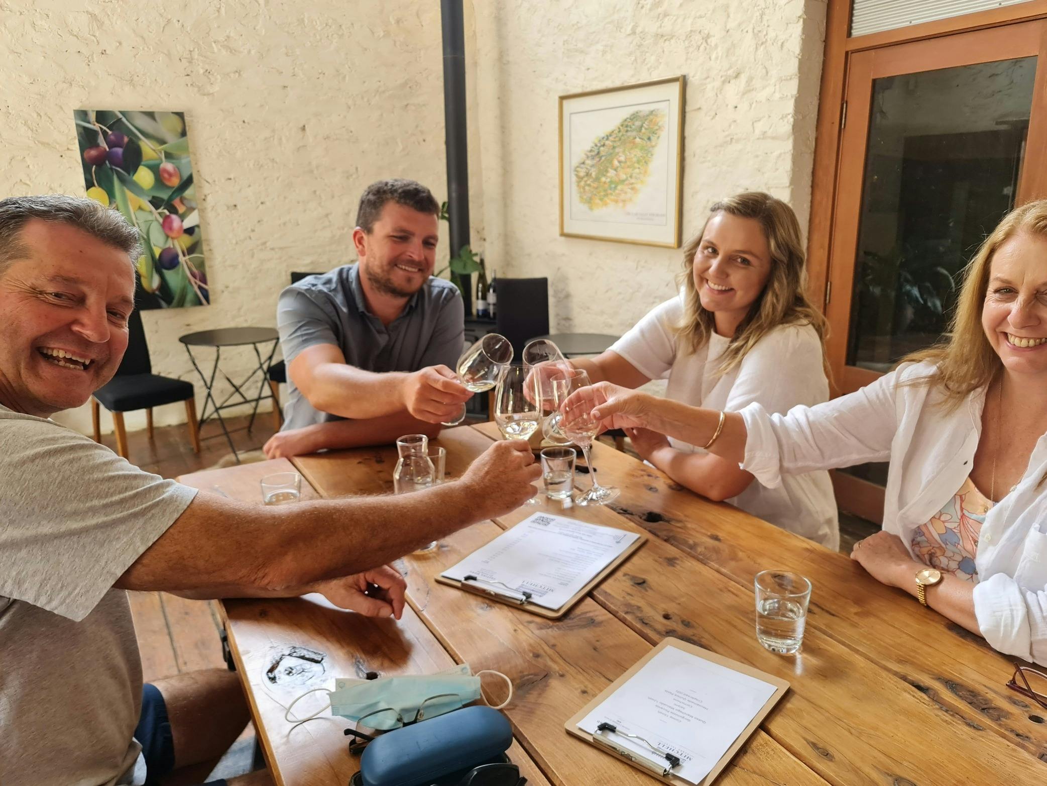 A family clinking glasses at a wine tasting.