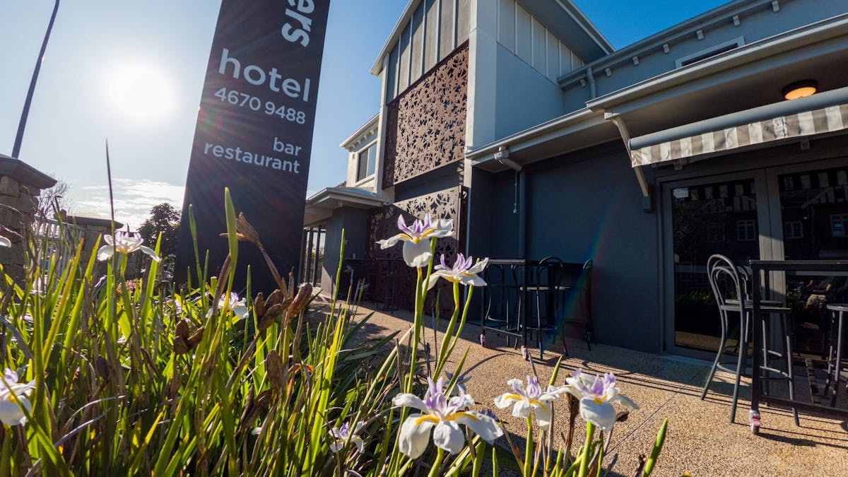 FRontage of the Hotel with the outside area of the Restaurant