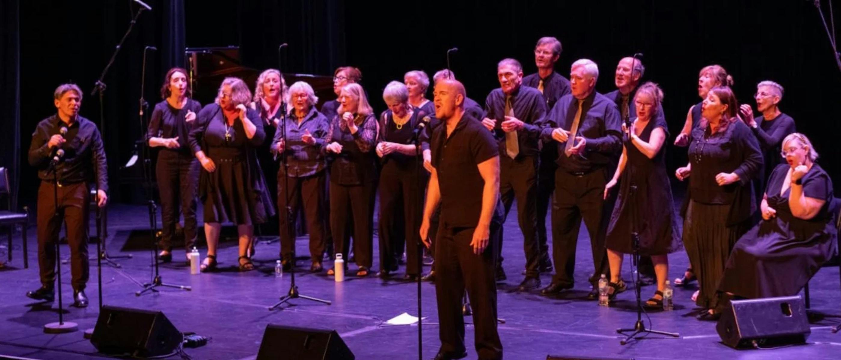 A group of gosepl singers singing and dancing on stage
