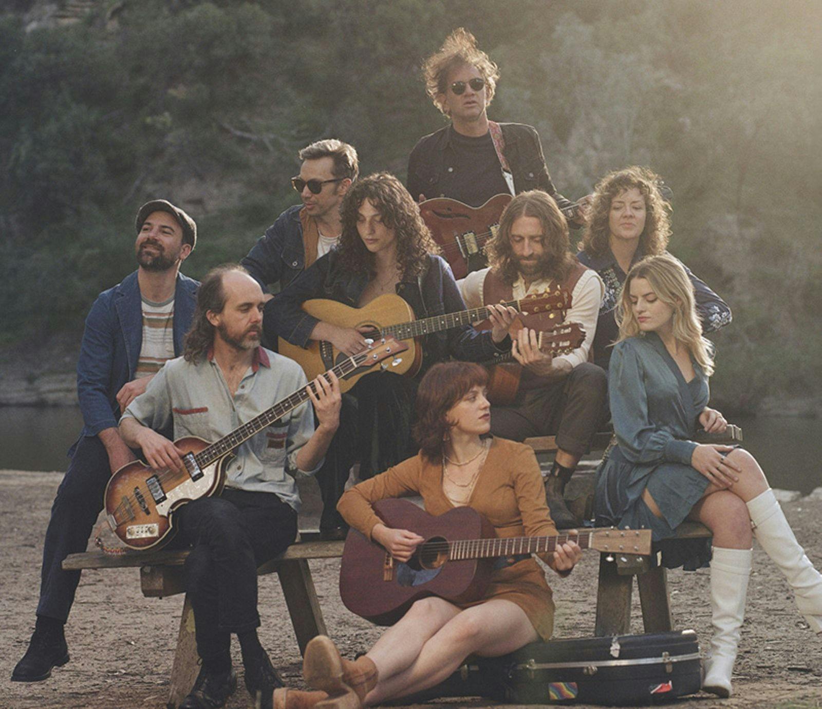 Songs from the Canyon band posing in front of trees at a park.