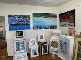 Large and small paintings on display in the gallery