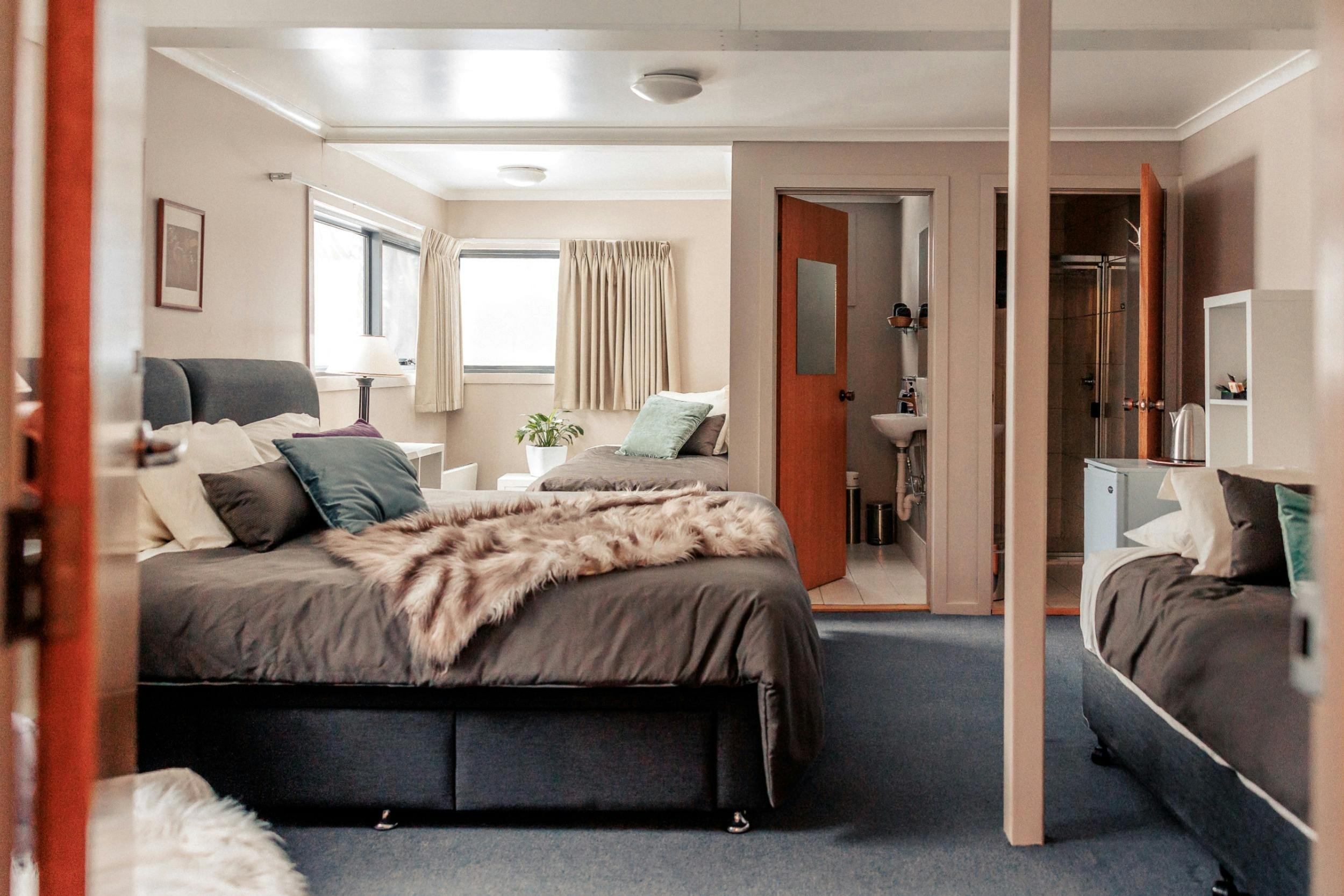 Four Share Room viewed from the door, super king, two single beds and bathroom