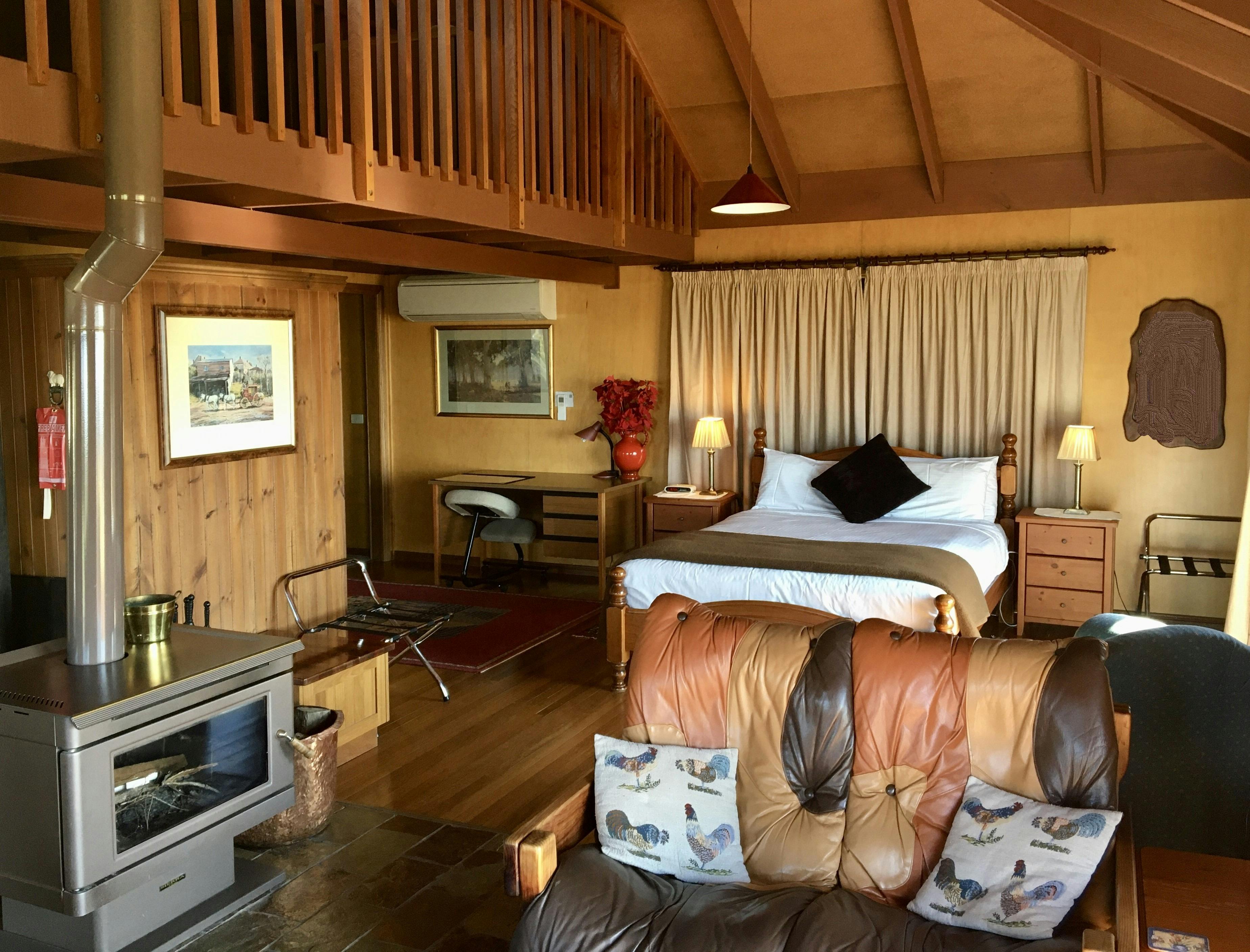 open plan floorplan showing bed and slow combustion fireplace