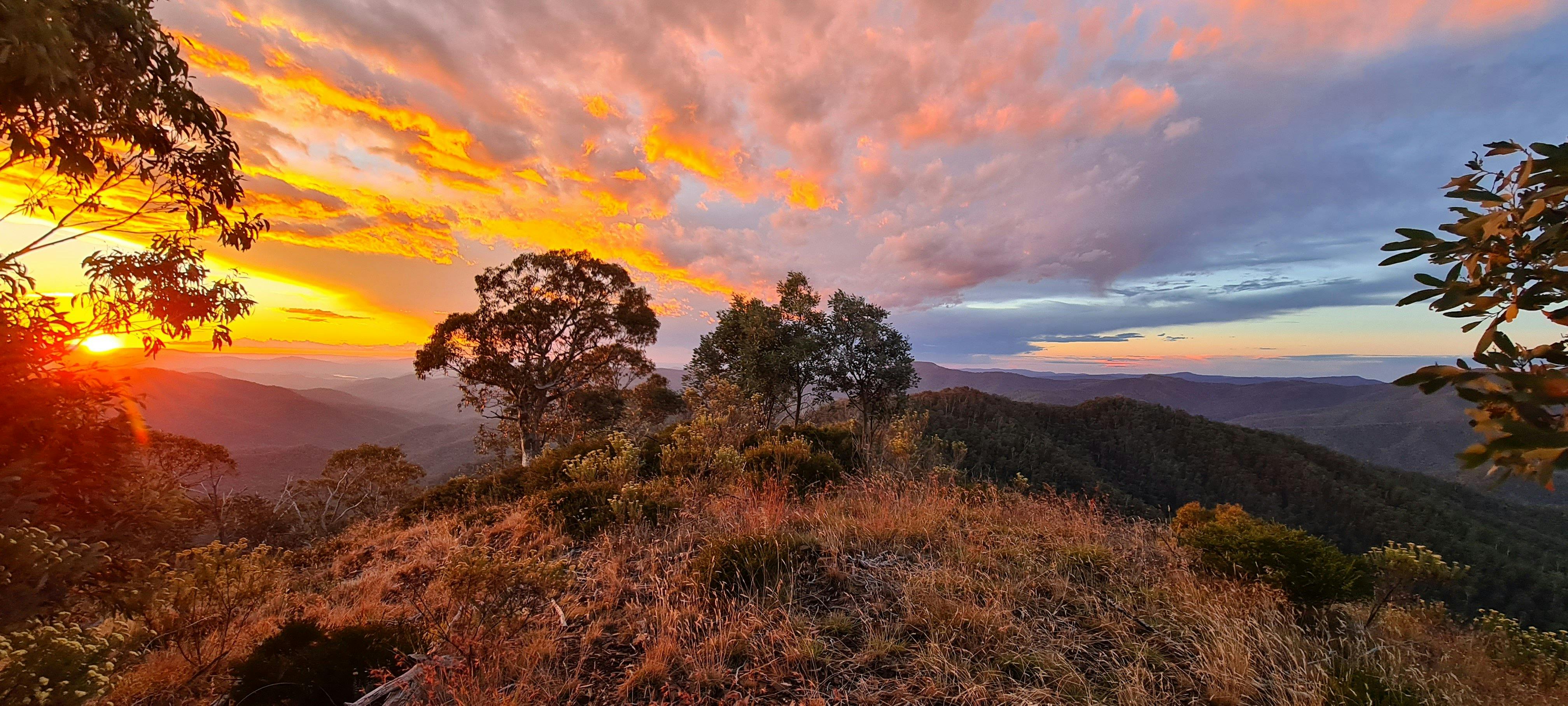 From Eagles Peaks, beautiful yellow and orange sunset colours spread across the sky.