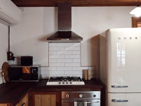 Kitchen with Smeg appliances and timber finishes at 1856 Cottage accommodation in Robe South Austral