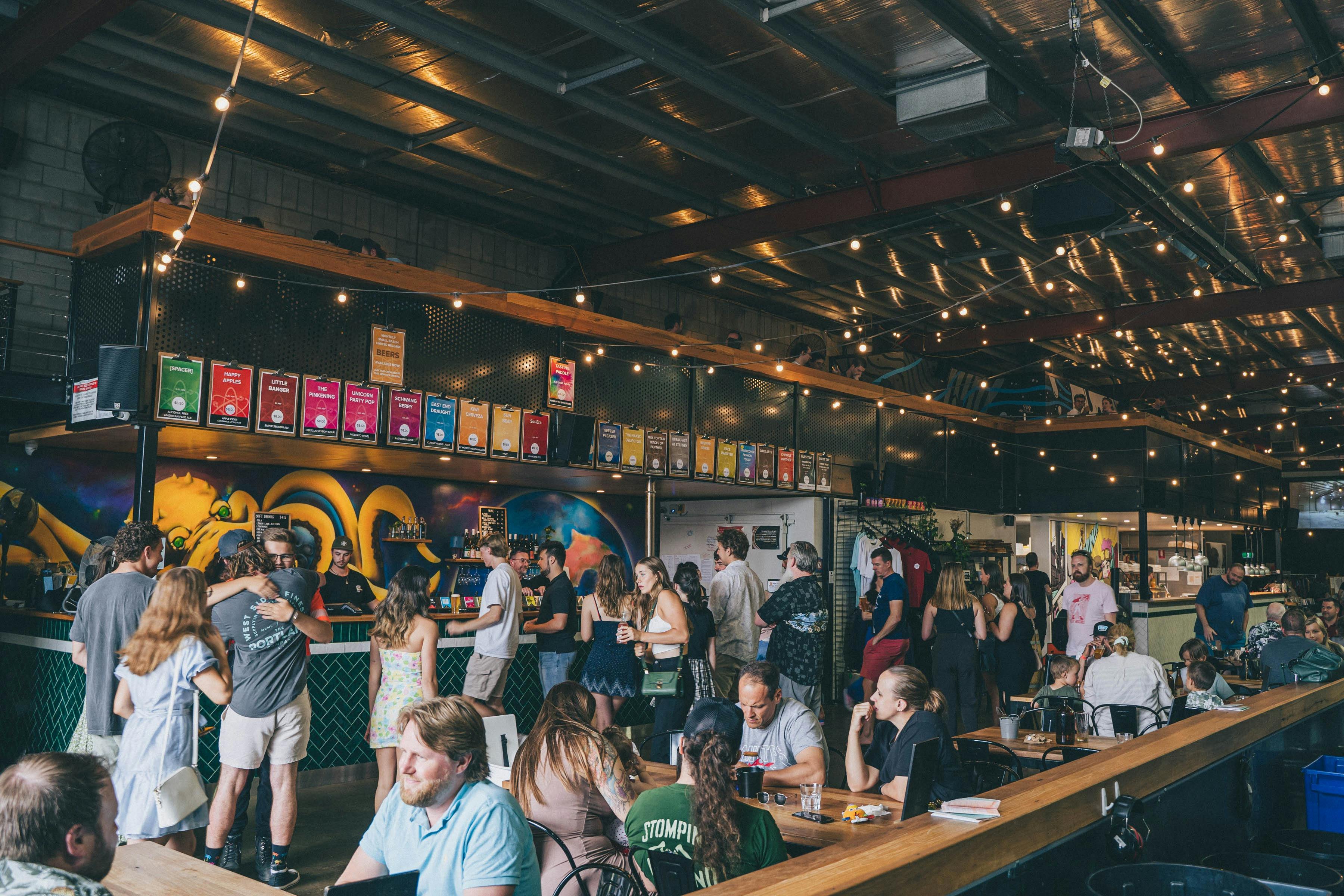 Interior of Little Bang Brewing Company at the Front Bar surrounded by patrons