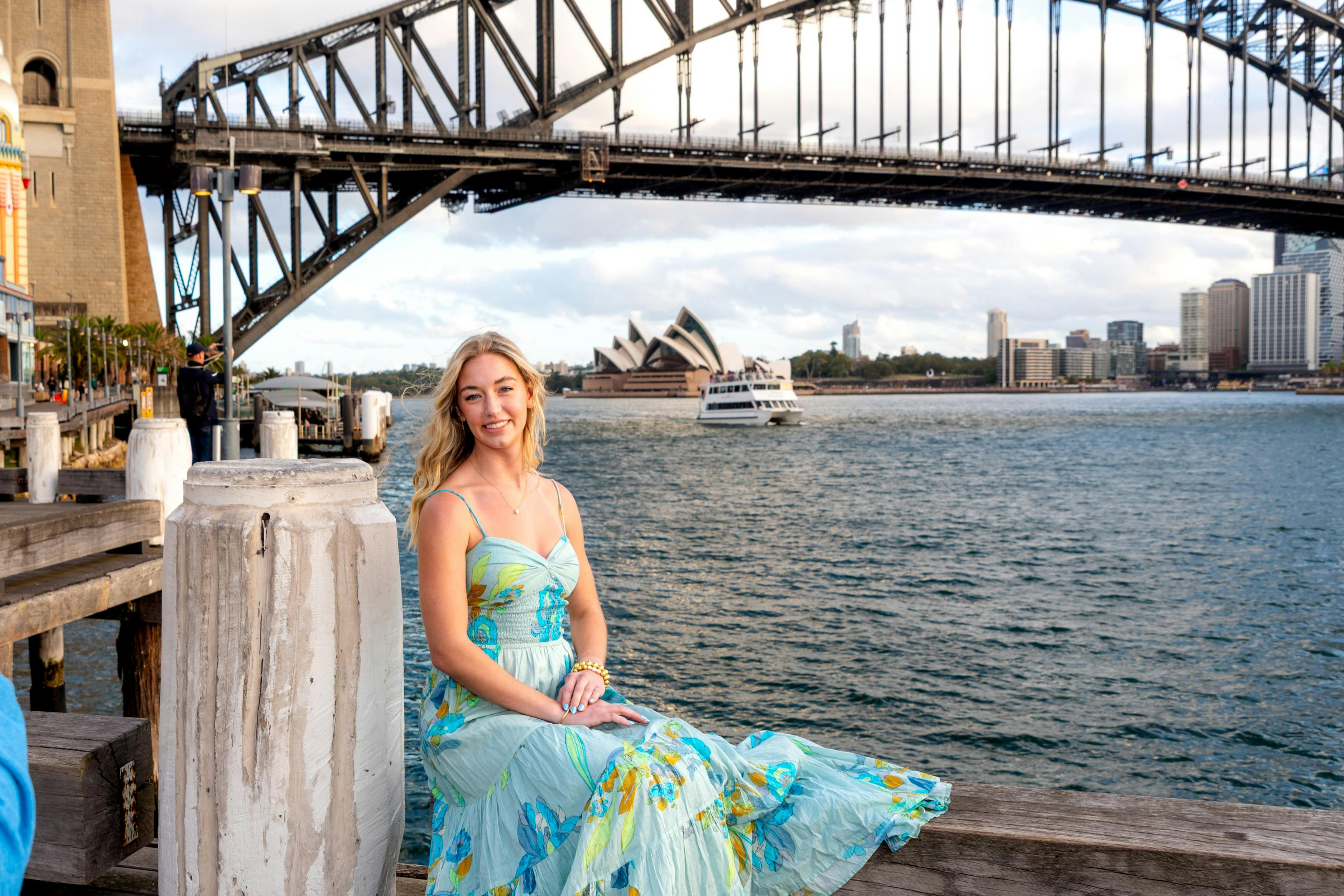 Lady seated on Sydney Harbour with Opera House background