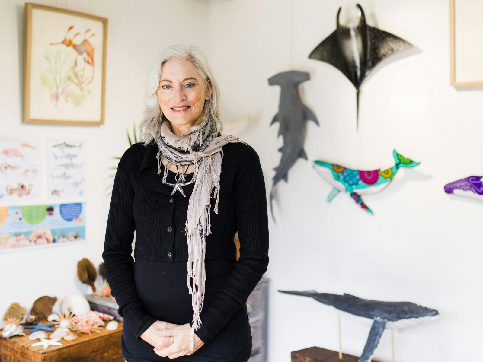 Artist Margot Hislop standing infront of her artwork