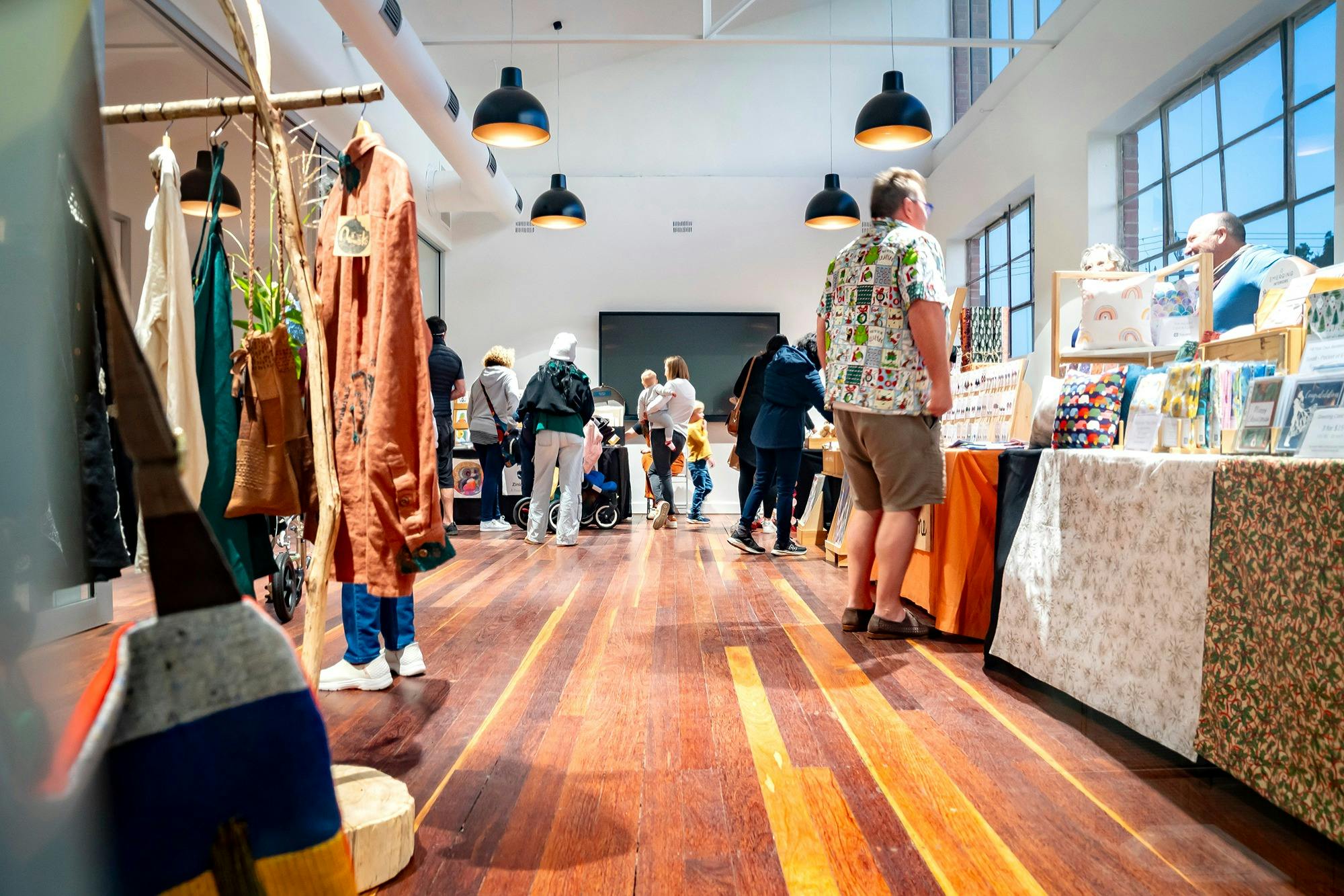 Evening outdoor stalls at FABRIK Arts + Heritage Handmade Christmas Market with festive lights