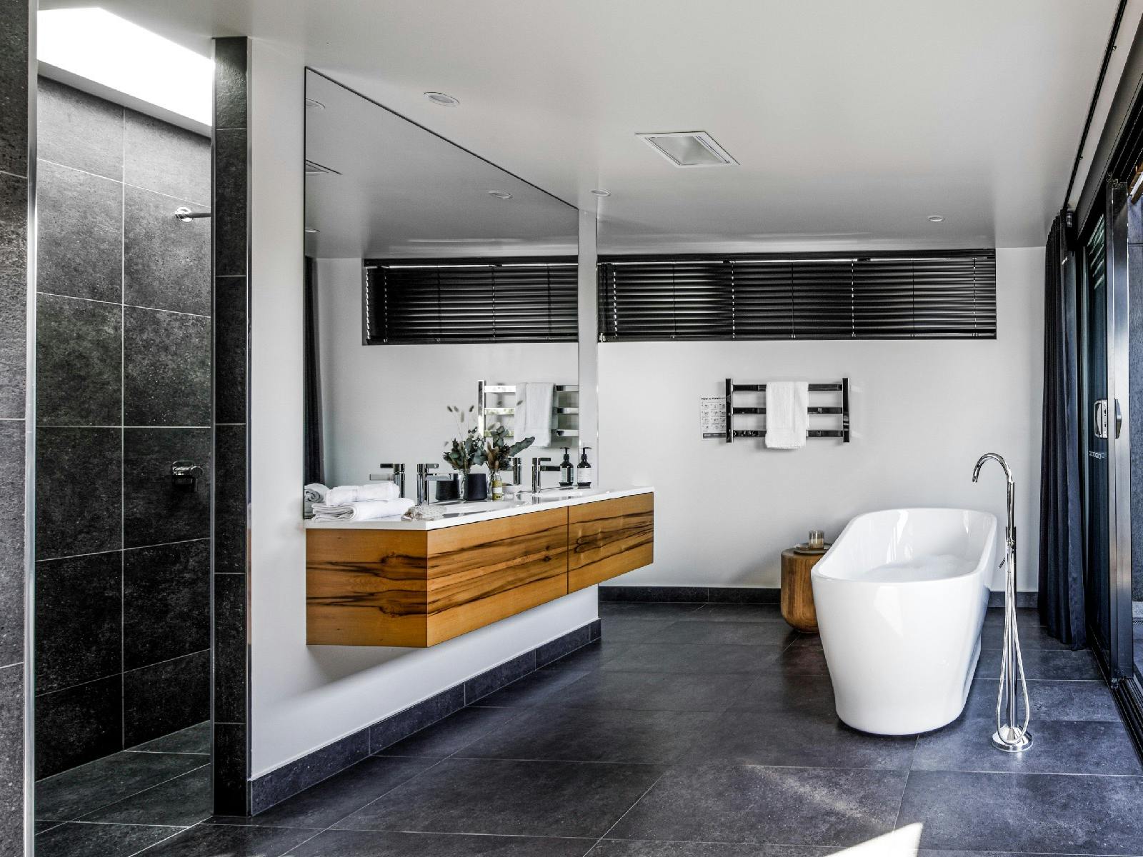 The second bedroom ensuite features a freestanding bath, double rain head showers.