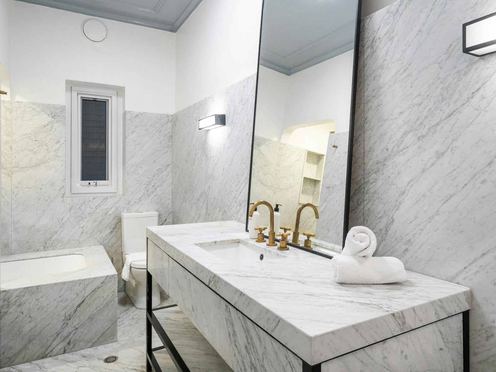 Modern bathroom with marble finishes and stylish fixtures.