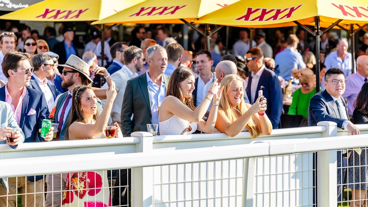 Patrons watching the races at Doomben Racecourse