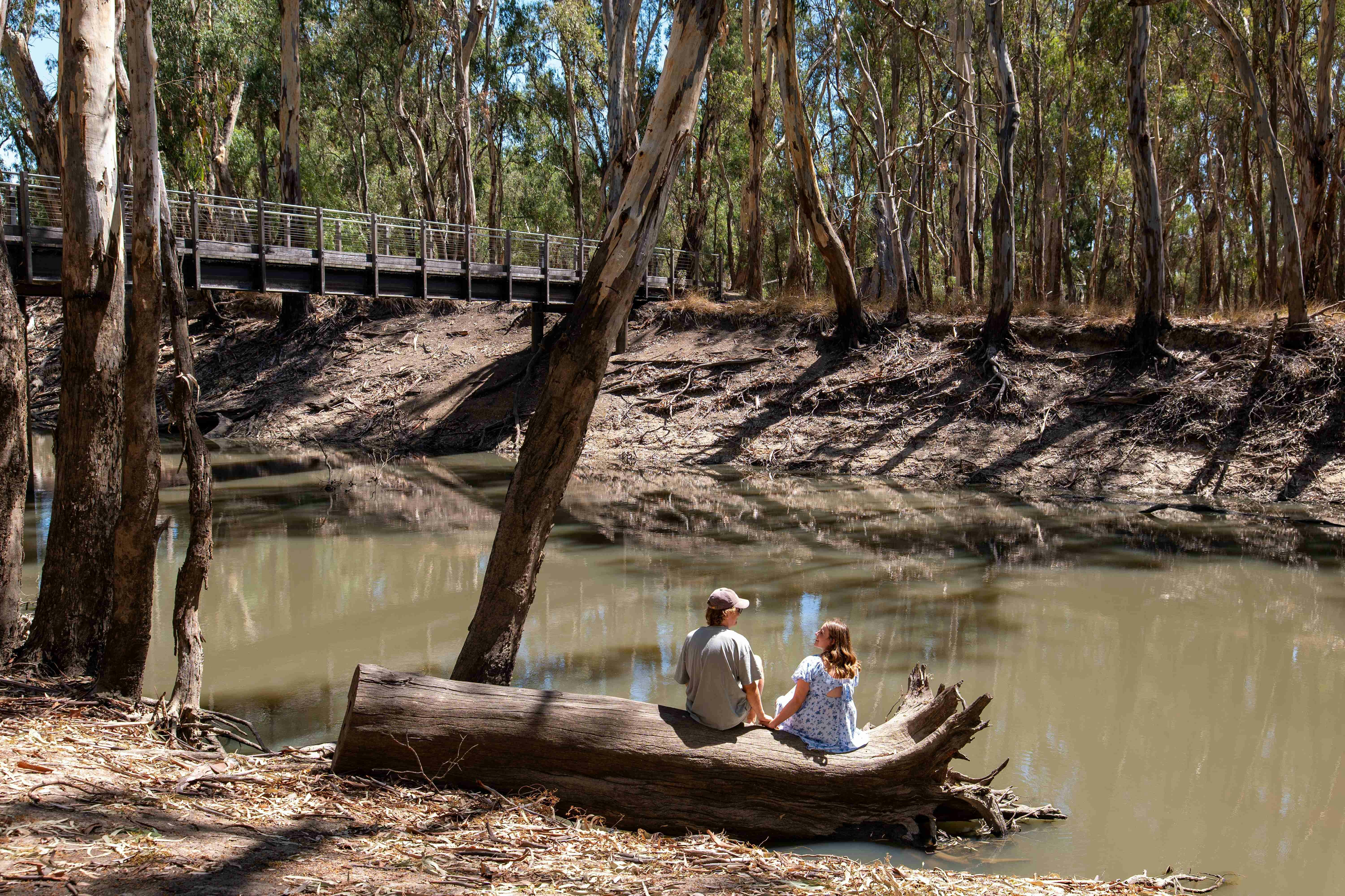 Couple relaxing by Gunbower Creek right out front of their Tent