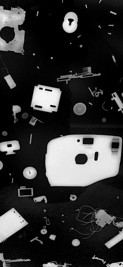 photogram of various camera parts. black and white photo