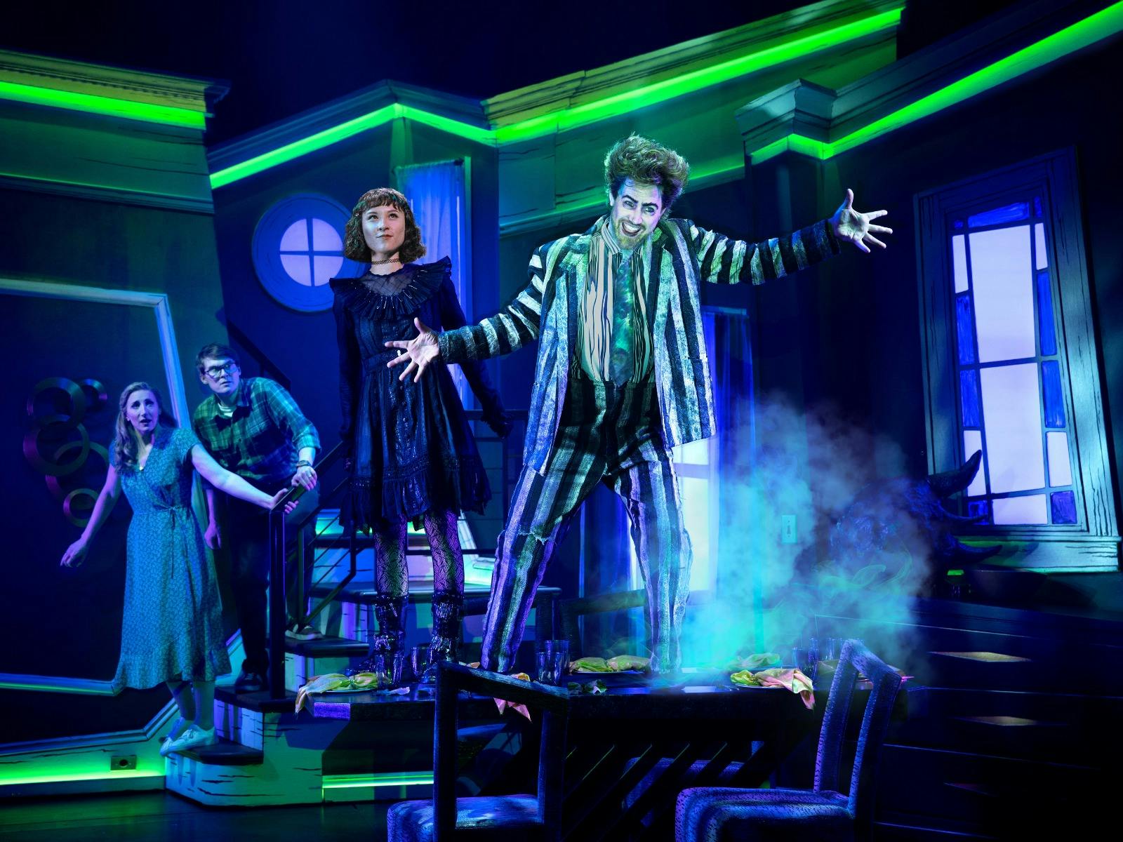 A young girl and a demon ghost stand on a table in a haunted house.