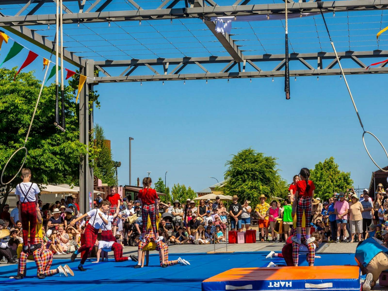 Young circus performers performing ground acrobatics outdoors at Junction Square, Wodonga.