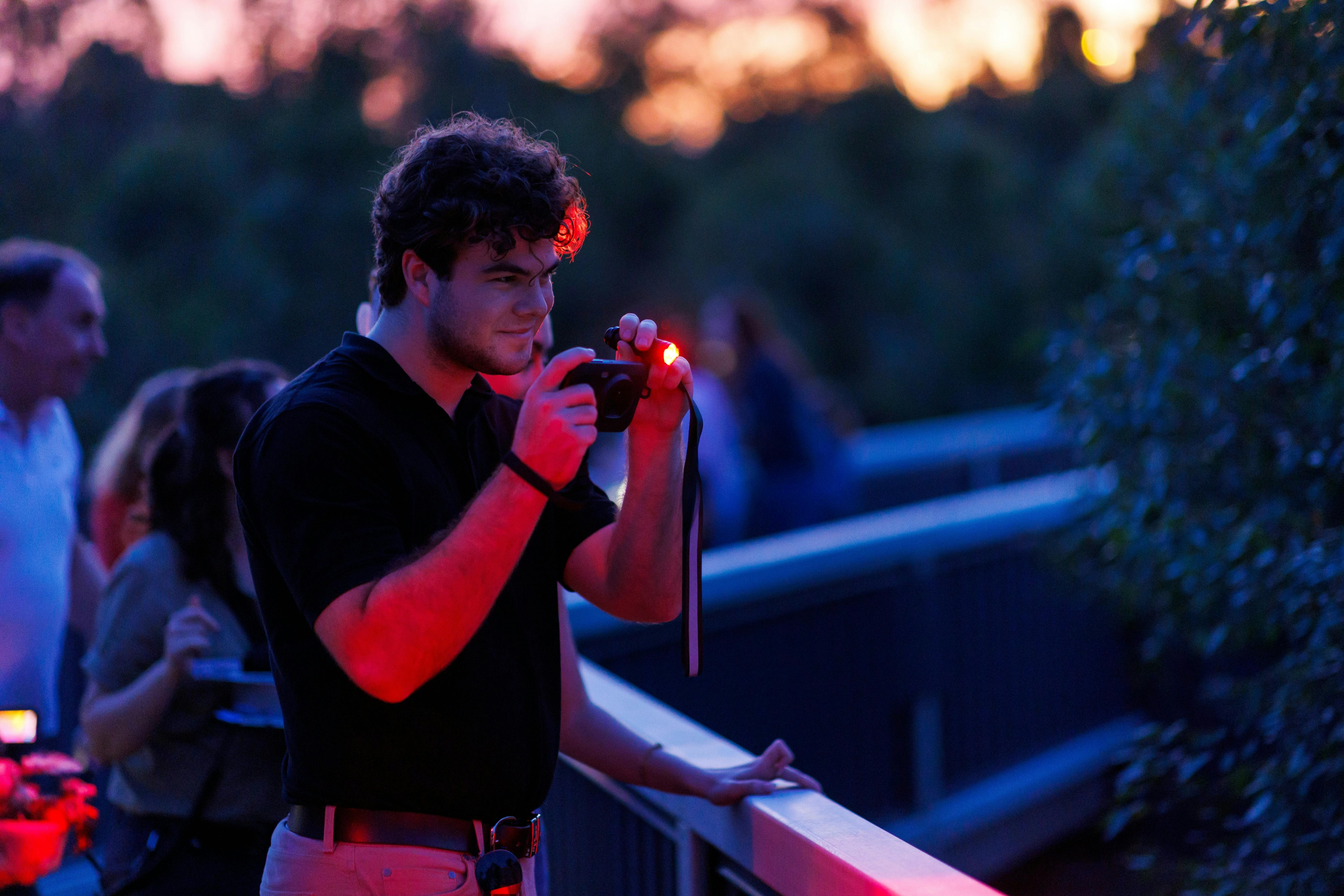 Guest at twilight looking through thermal imaging camera at Australian wildlife