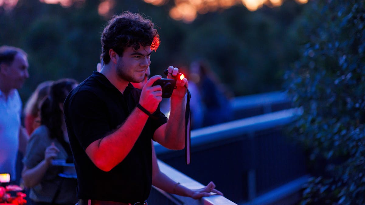 Guest at twilight looking through thermal imaging camera at Australian wildlife