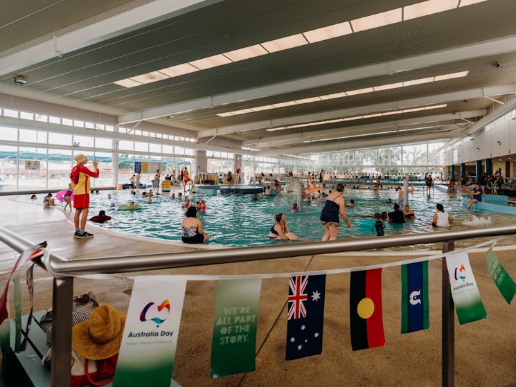 Image of people swimming at Bathurst Pool with Australia bunting around the pool.