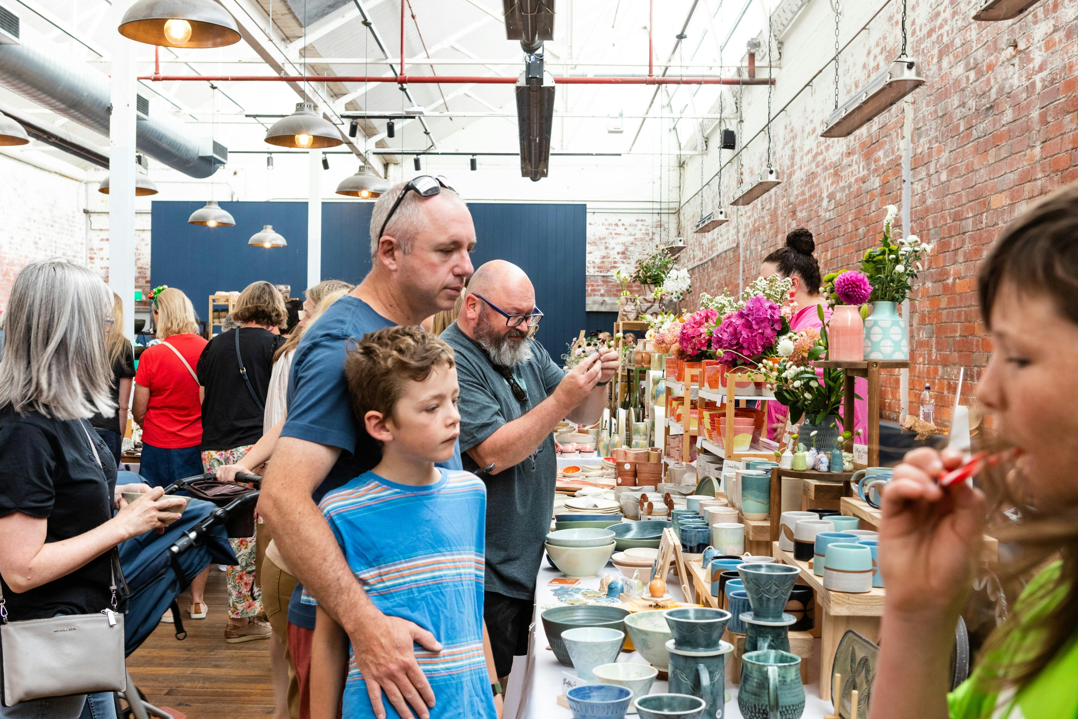 Crowds browsing handmade ceramics at the Geelong Ceramics Market inside Furphy Hall