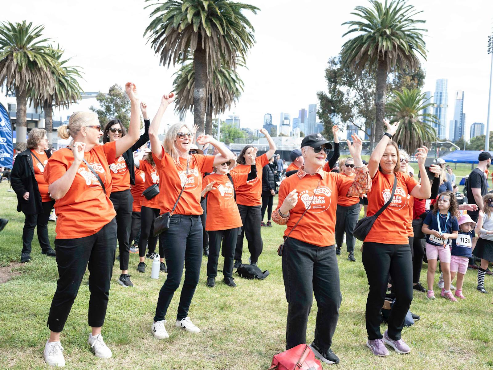 People dancing in Life's Little Treasures Foundation t-shirts