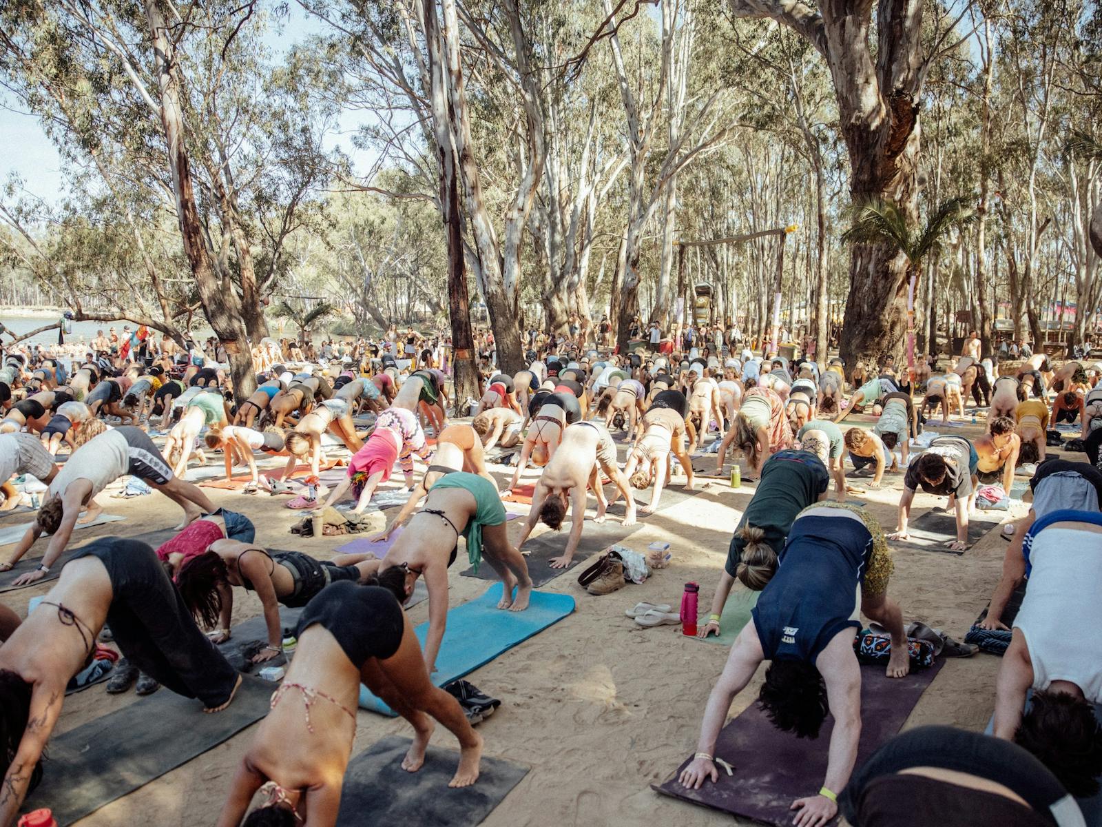 People doing yoga on the beach at Strawberry Fields Festival