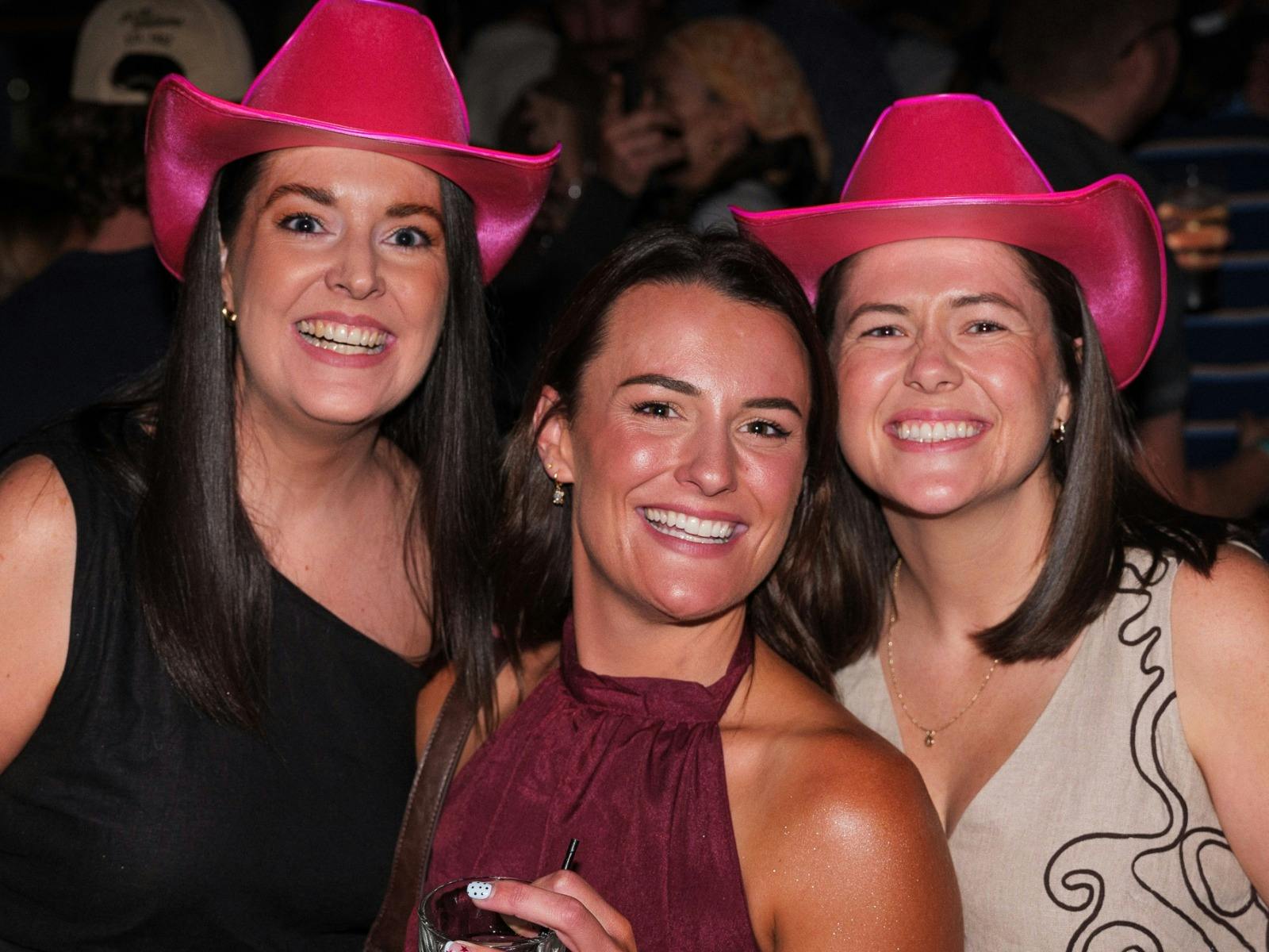 Three friends in cowboy hats enjoying NYE
