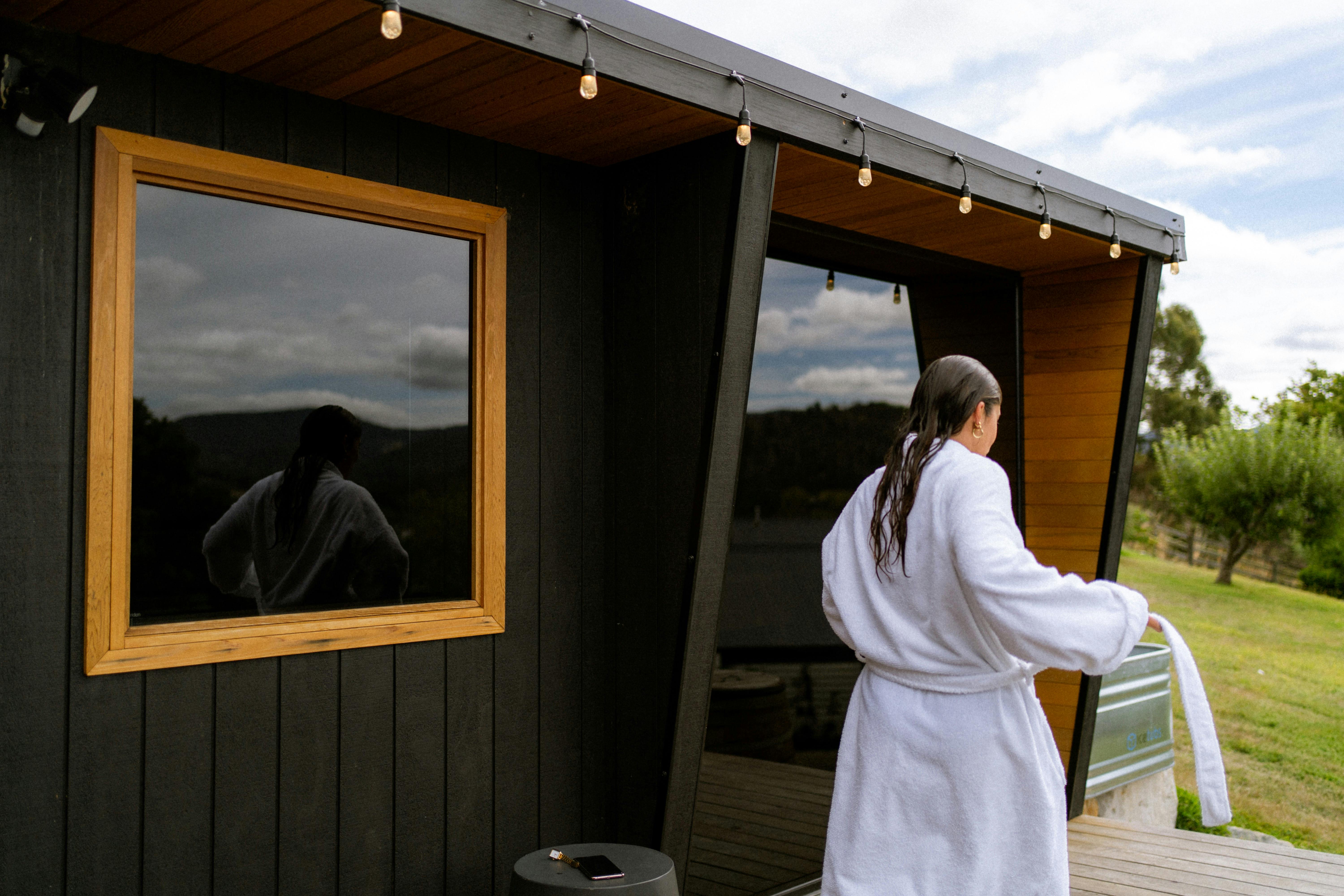 Loz walking with her robe out of the Sauna