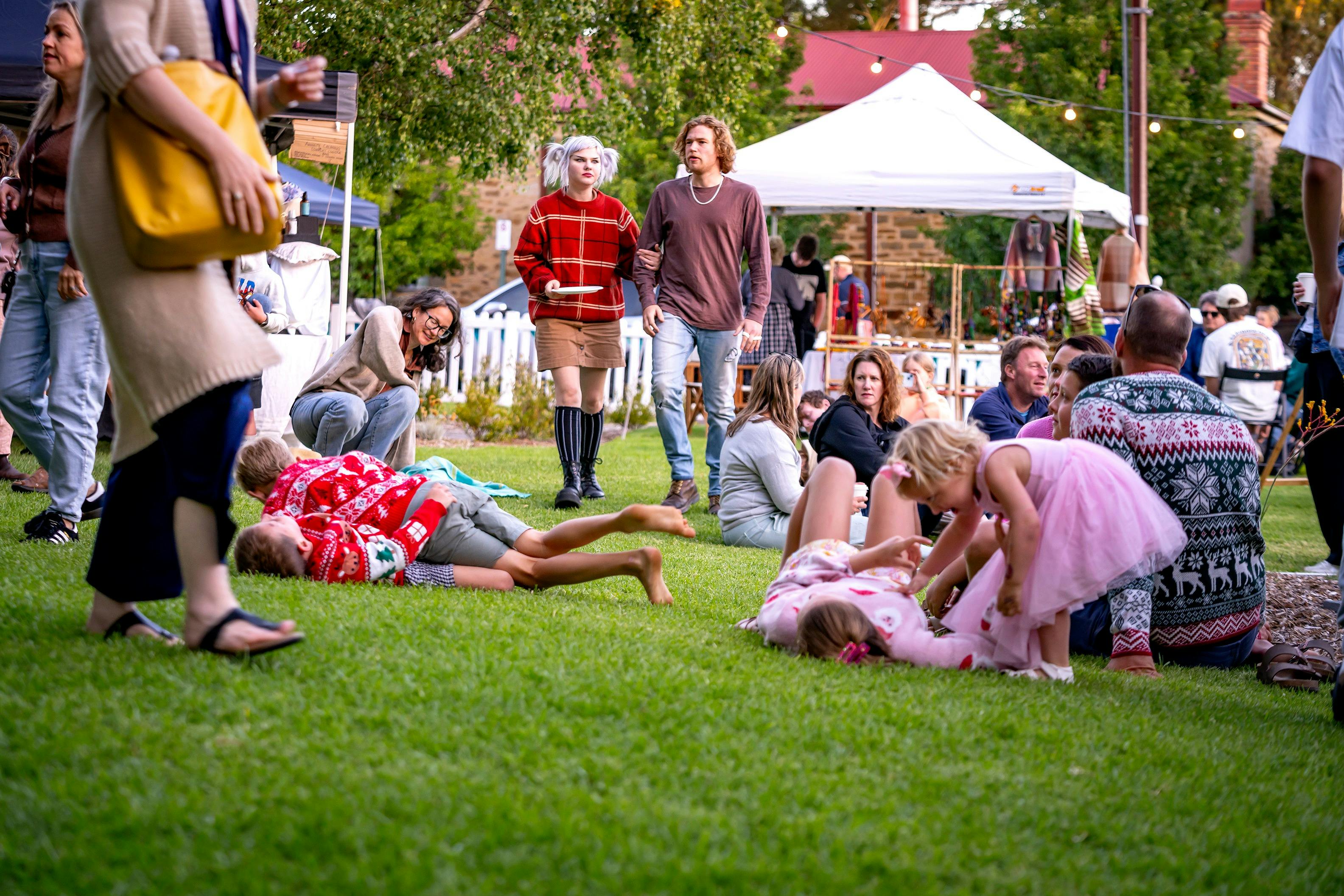 Families relaxing on the lawn at FABRIK Arts + Heritage Handmade Christmas Market