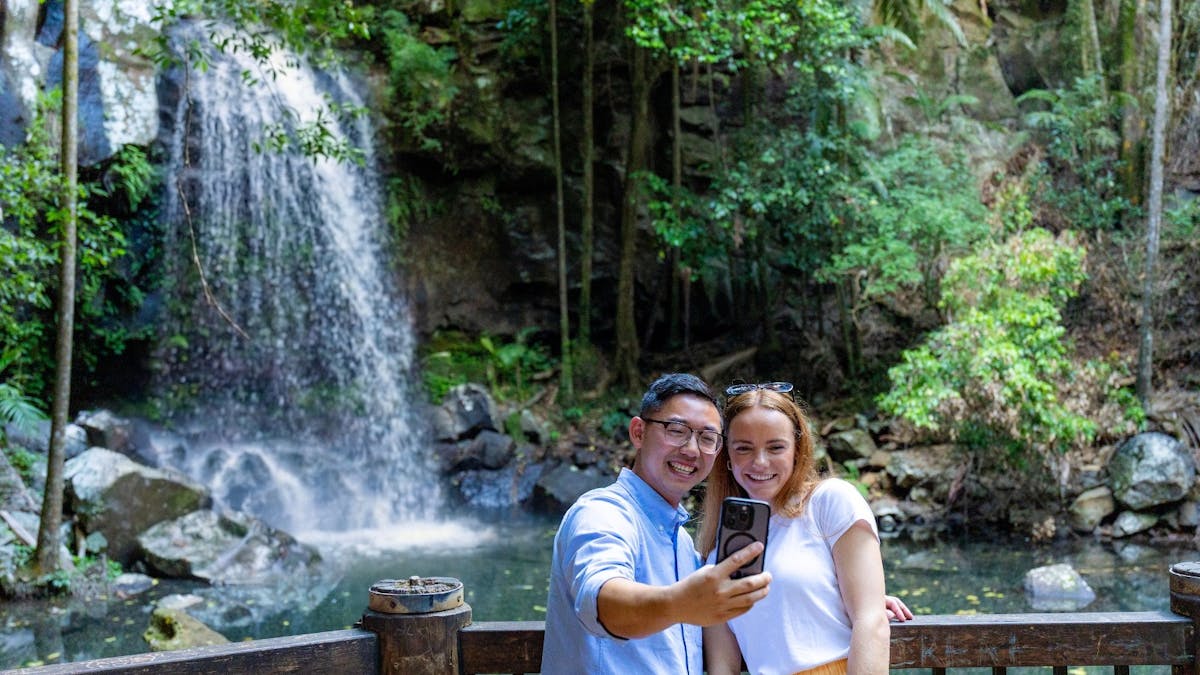 2 people taking a selfie in front of Curtis Falls