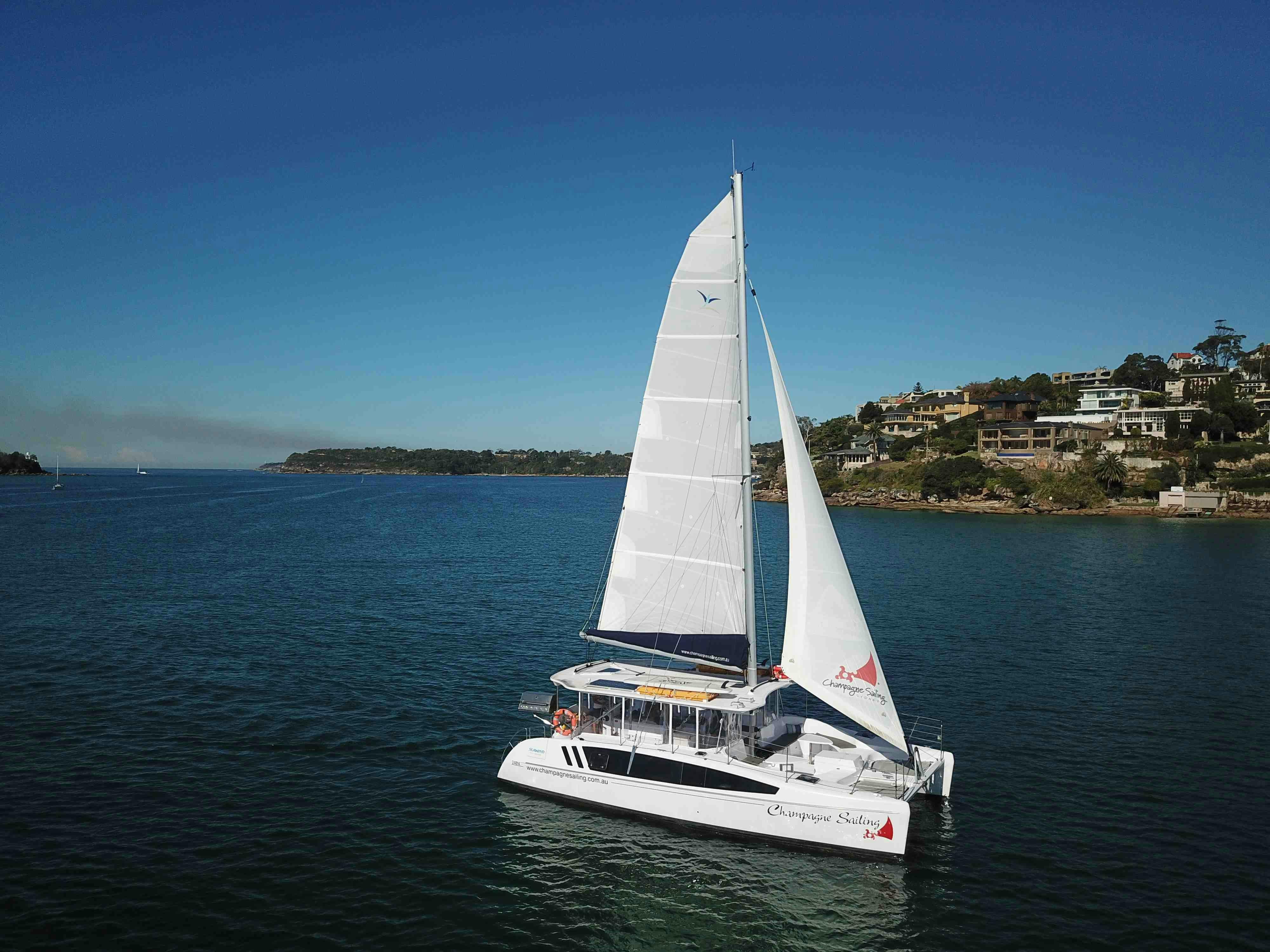 Champagne Sailing catamaran under sail on Sydney Harbour
