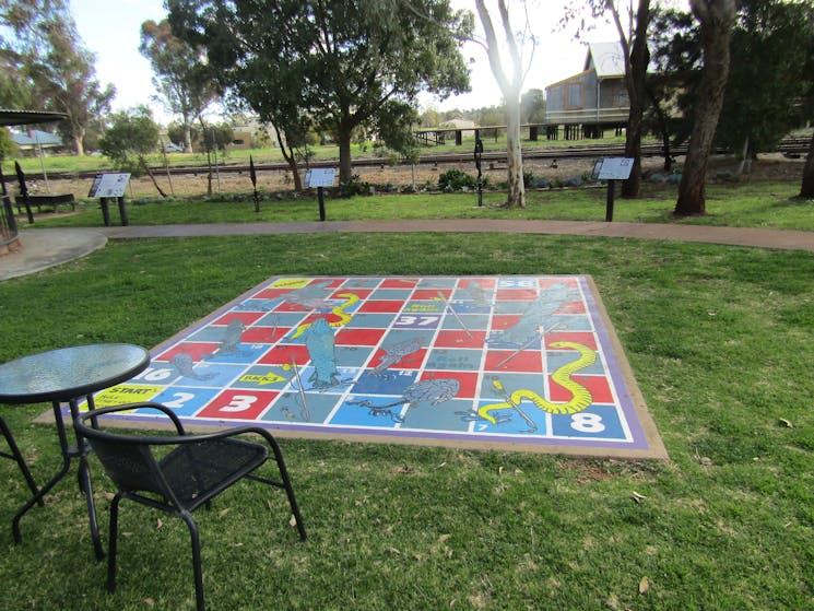 Grass area with giant board game set in to it