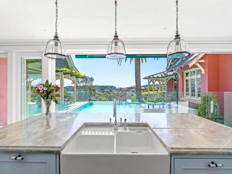 Kitchen overlooking stunning poolside scenery