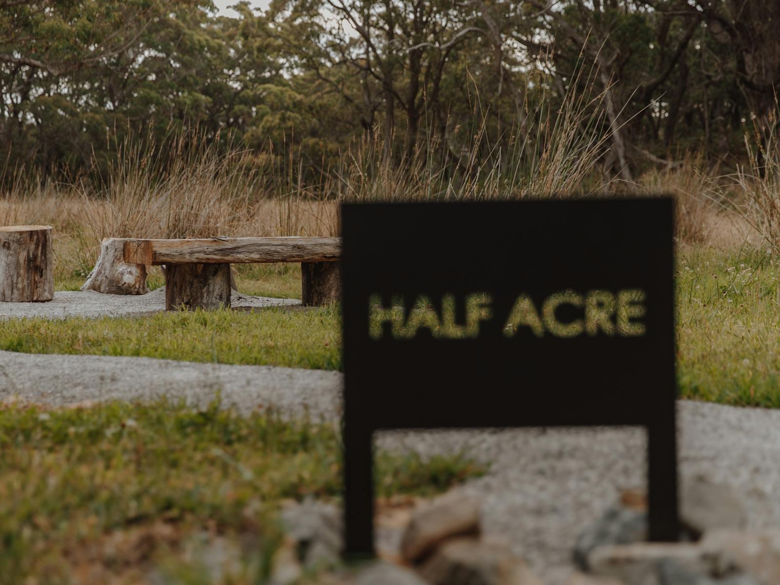A metal sign in front of an outdoor living area
