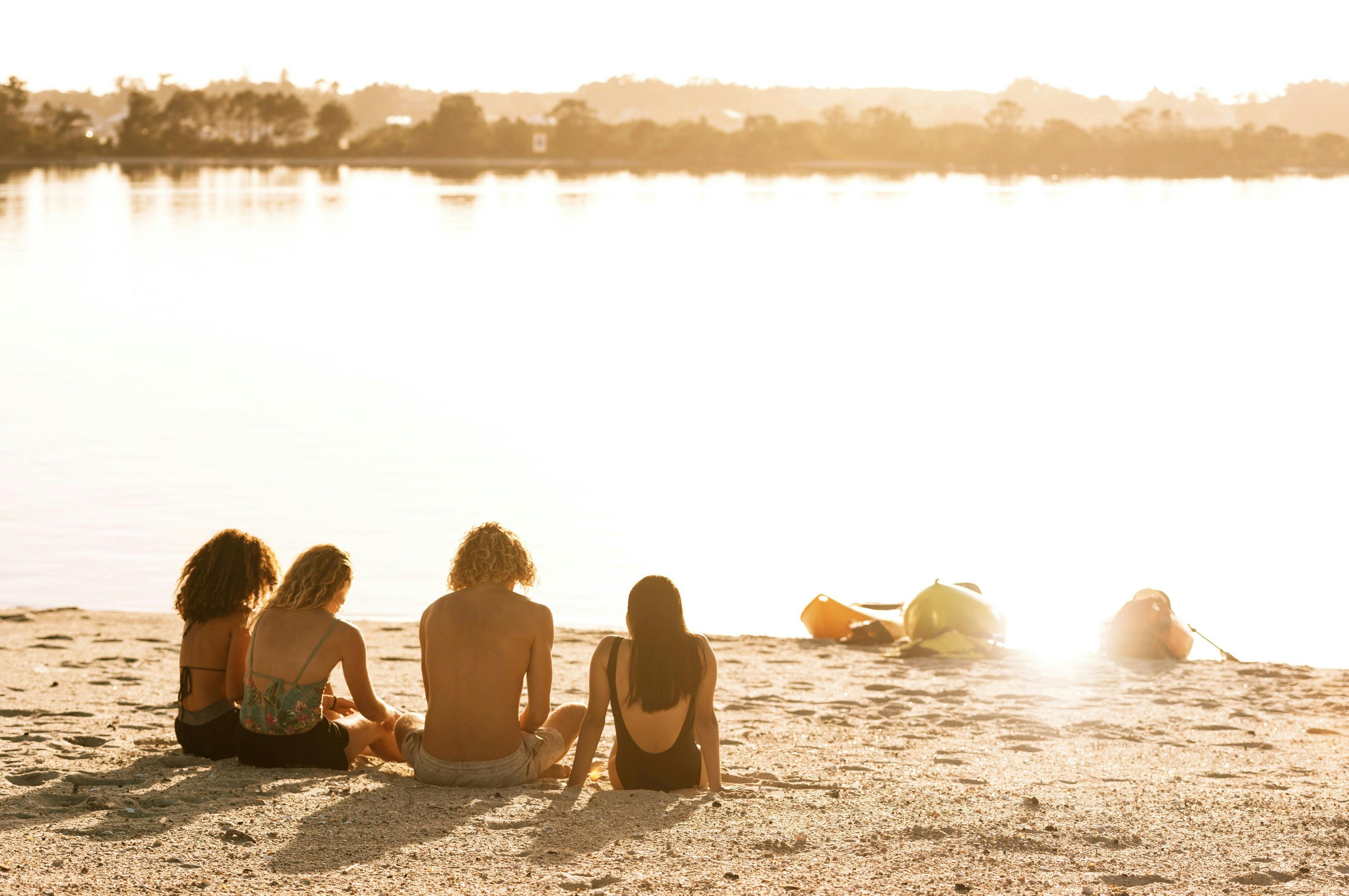 Friends enjoying a day of kayaking on Lake Maquarie off Naru Beach