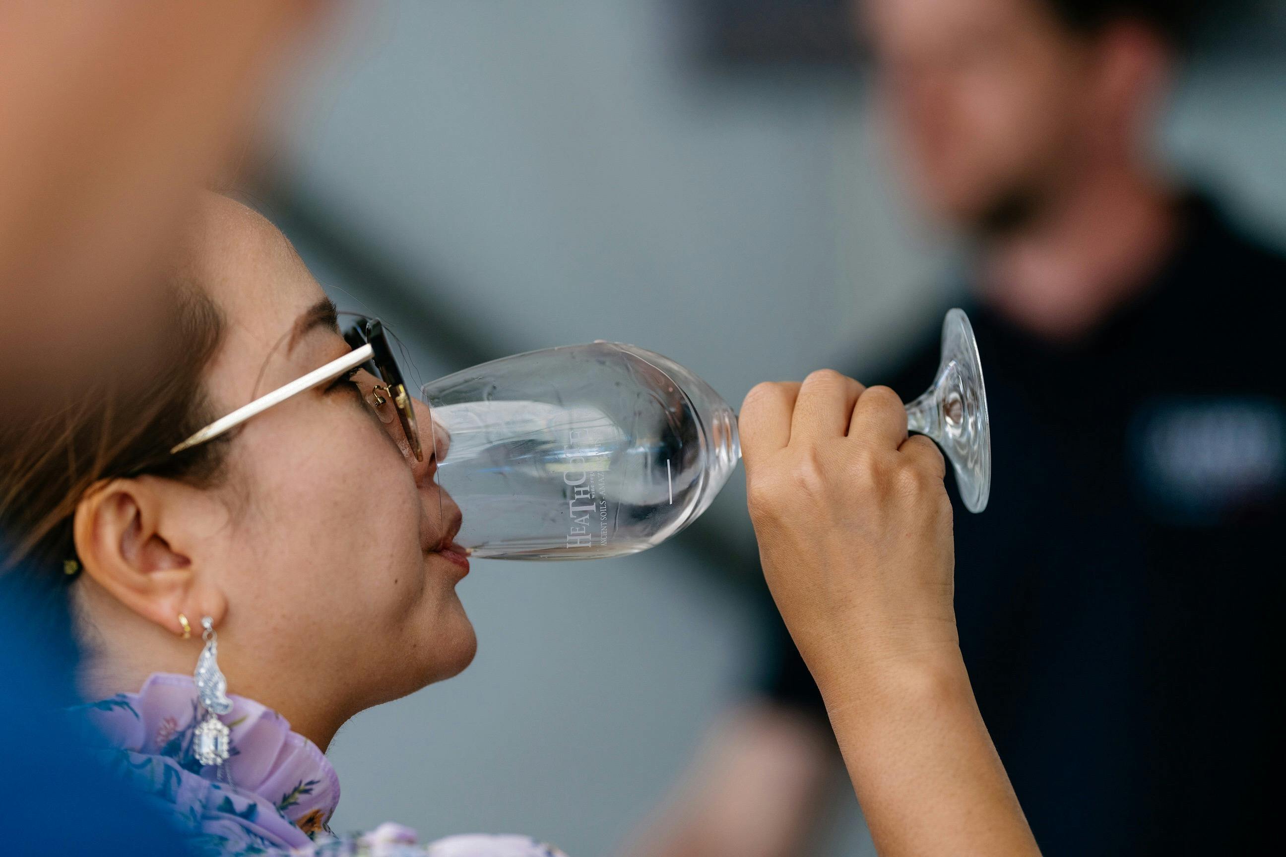Woman drinking wine in Heathcote glass
