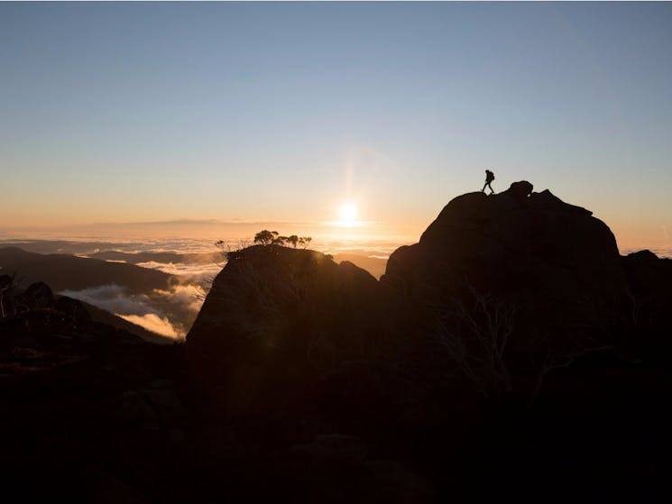 Hiker enjoying a scenic sun set at Kosciuszko National Park, Kosciuszko