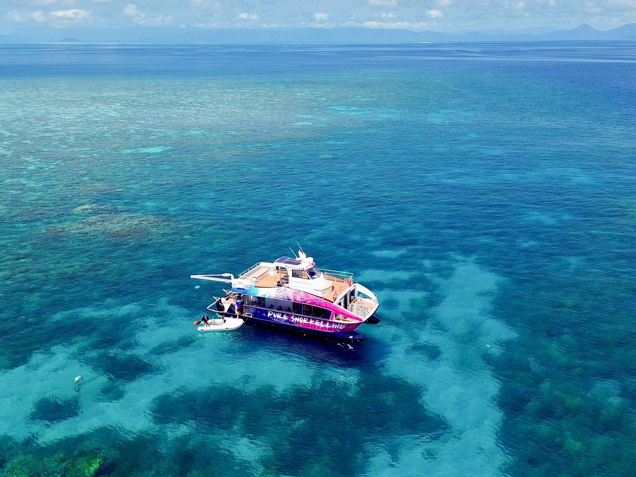Drone shot of the Pure snorkelling boat at Briggs reef, snorkel site fish bowl Drone shot of the Pure snorkelling boat at Briggs reef, snorkel site fish bowl