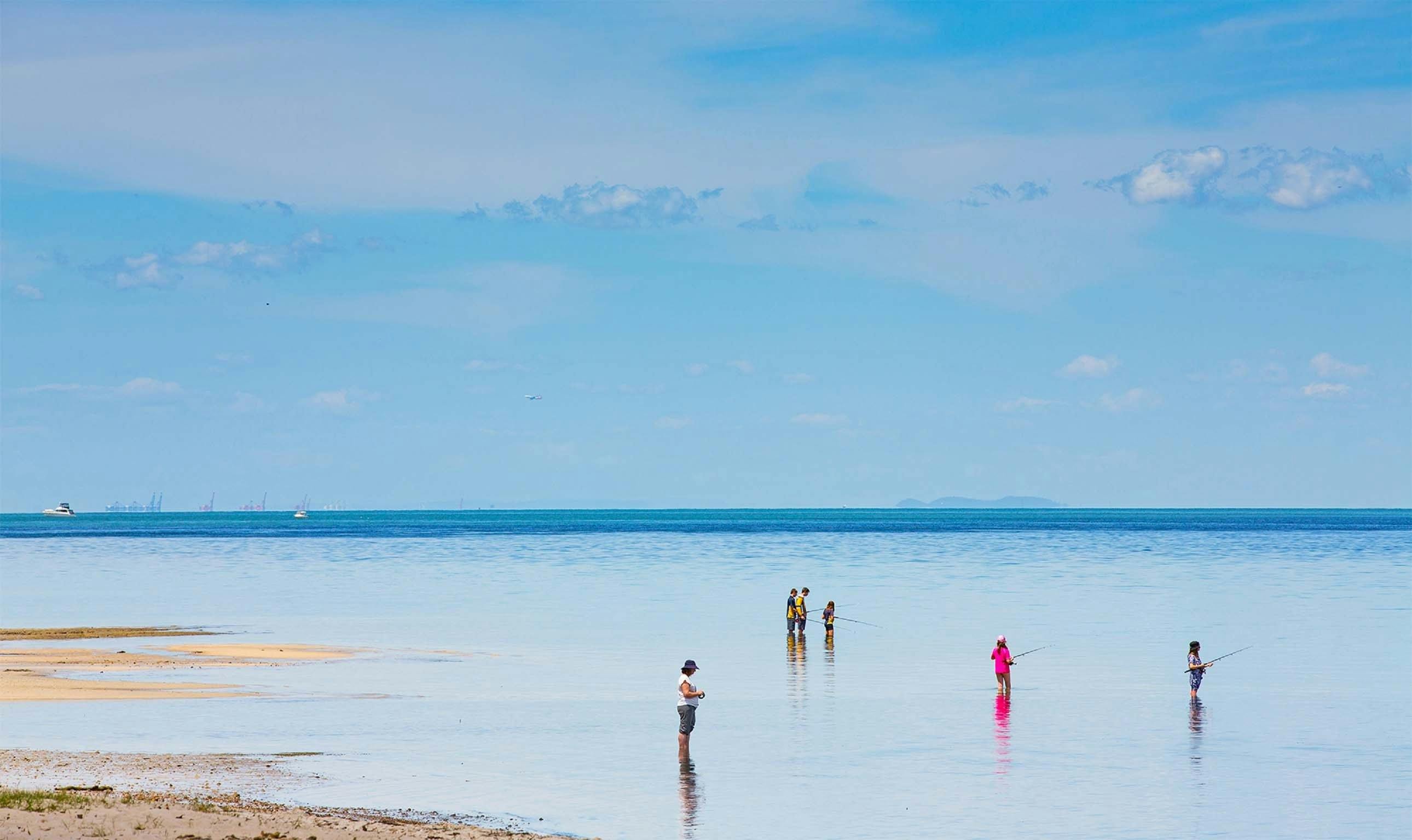A number of people fishing at Bongaree Beach, Bribie Island